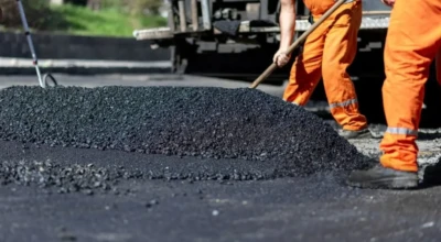 Homens trabalhando na construção do asfalto.